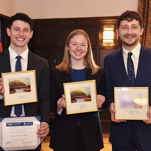 Lane Kadish '25, Sophie Keller '26, and Michael F. Johnson '25 join Professor Craig Johnston in celebratory photo after winning the 2025 ...