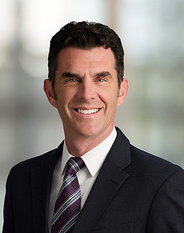 Office or university building blur background exterior view with blurry empty lobby space, entrance hall glass wall window and light bokeh