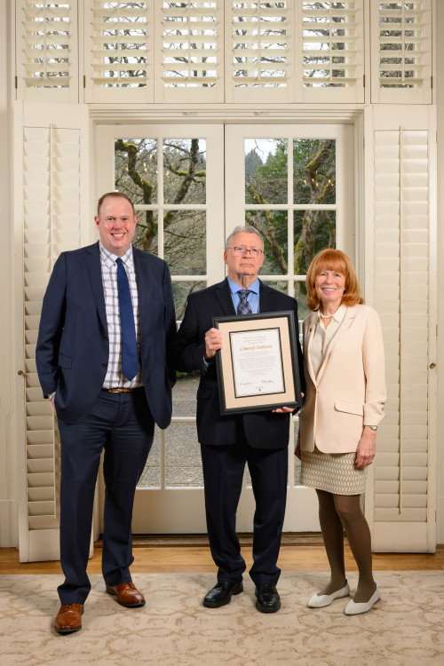 Ed Sullivan, Honorary Graduate standing with Brad Krupicka '10 and Dean Jennifer Johnson