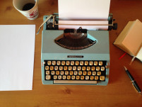 Typewriter and coffee cup