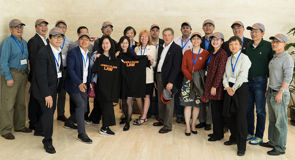 The alumni reunion group pose with Lewis &  Clark Law School swag.
